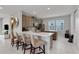 Modern kitchen with L-shaped island, quartz countertops, and stainless steel appliances at 7694 Graben St, Kissimmee, FL 34747