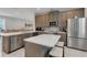Open concept kitchen with large island, stainless steel appliances, and quartz countertops at 7694 Graben St, Kissimmee, FL 34747