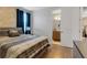 Bedroom with wood floors and access to bathroom at 7694 Graben St, Kissimmee, FL 34747