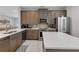 Modern kitchen with stainless steel appliances and an island with seating at 7694 Graben St, Kissimmee, FL 34747