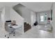 Bright entryway with tile floors, staircase, and built-in workspace at 7694 Graben St, Kissimmee, FL 34747