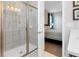 Bathroom with a walk-in shower and bedroom access at 7694 Graben St, Kissimmee, FL 34747
