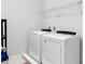 Bright laundry room with washer, dryer, and shelving at 7694 Graben St, Kissimmee, FL 34747