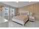Spacious bedroom with a king-size bed, neutral color palette, and ample natural light at 7694 Graben St, Kissimmee, FL 34747