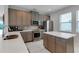 Modern kitchen with stainless steel appliances and an island with seating at 7694 Graben St, Kissimmee, FL 34747