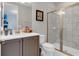 Modern bathroom with gray cabinets and a walk-in shower at 7694 Graben St, Kissimmee, FL 34747