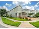 Two-story house showcasing a brick facade and landscaping at 7694 Graben St, Kissimmee, FL 34747
