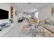 Open concept living area with a view into the dining room and kitchen, featuring comfortable seating at 7694 Graben St, Kissimmee, FL 34747