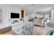 Open living area showcasing a sleek TV wall, comfortable seating, and a modern glass coffee table at 7694 Graben St, Kissimmee, FL 34747