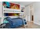 Bunk bed in a bedroom with a mural and hardwood floor at 7694 Graben St, Kissimmee, FL 34747