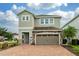 Two-story house with stone accents and a two-car garage at 7694 Graben St, Kissimmee, FL 34747
