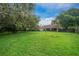 Green grassy backyard with a view of the house at 2818 Se 24Th Ave, Ocala, FL 34471