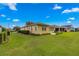 Large backyard with grassy area and home view at 9823 Sw 95Th Loop, Ocala, FL 34481