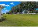 Landscaped backyard with lush green grass and mature trees at 9823 Sw 95Th Loop, Ocala, FL 34481