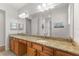 Double vanity bathroom with granite countertop and large mirror at 9823 Sw 95Th Loop, Ocala, FL 34481