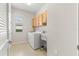 Bright laundry room with washer, dryer, and storage cabinets at 9823 Sw 95Th Loop, Ocala, FL 34481