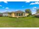 Large backyard with grassy area and home view at 9823 Sw 95Th Loop, Ocala, FL 34481