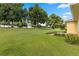 Grass backyard with mature trees and partial home view at 9823 Sw 95Th Loop, Ocala, FL 34481