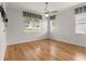 Spacious bedroom with hardwood floors and ceiling fan at 9823 Sw 95Th Loop, Ocala, FL 34481