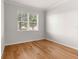 Bedroom with hardwood floors and window with blinds at 9823 Sw 95Th Loop, Ocala, FL 34481