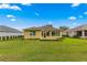 Spacious backyard with grassy area and home view at 9823 Sw 95Th Loop, Ocala, FL 34481