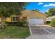 House exterior with a two-car garage and landscaping at 9823 Sw 95Th Loop, Ocala, FL 34481