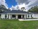 Modern farmhouse exterior with covered porch at 1965 County Road 243C, Wildwood, FL 34785