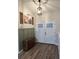 Bright entryway with wood-look floors, stylish storage, and double doors at 1965 County Road 243C, Wildwood, FL 34785