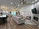 Open living space with high ceilings, hardwood floors, and a modern fireplace at 1965 County Road 243C, Wildwood, FL 34785