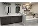 Elegant bathroom with double vanity, soaking tub, and modern fixtures at 1965 County Road 243C, Wildwood, FL 34785