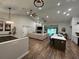Open concept kitchen with island, white cabinets, and stainless steel appliances at 1965 County Road 243C, Wildwood, FL 34785