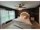 Spacious bedroom with dark walls, large window, and a king-size bed at 1965 County Road 243C, Wildwood, FL 34785
