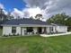 Modern farmhouse exterior with covered porch and two-car garage at 1965 County Road 243C, Wildwood, FL 34785