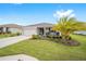 Single-story home with a two-car garage and lush landscaping at 8924 Sw 76Th Ln, Ocala, FL 34481