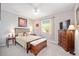 Well-lit bedroom with a queen-size bed, dresser, and window at 8924 Sw 76Th Ln, Ocala, FL 34481
