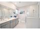 Spa-like bathroom with double vanity, large shower, and neutral tile at 8924 Sw 76Th Ln, Ocala, FL 34481