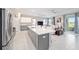 Modern kitchen with an island, stainless steel appliances, and white cabinets at 8924 Sw 76Th Ln, Ocala, FL 34481