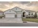 Two-story house with a three-car garage, stone accents, and a beautifully landscaped yard at 8314 Sw 59Th Ter, Ocala, FL 34476