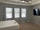 Primary bedroom with large windows and ceiling fan at 8314 Sw 59Th Ter, Ocala, FL 34476