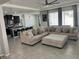 Open concept living room with a large sectional sofa and adjacent kitchen at 8314 Sw 59Th Ter, Ocala, FL 34476