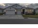 Two-story house with a three-car garage, stone accents, and a beautifully landscaped yard at 8314 Sw 59Th Ter, Ocala, FL 34476