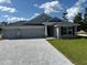 Newly built home with three-car garage and stone accents at 7160 Sw 179Th Court Rd, Dunnellon, FL 34432