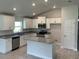 Modern kitchen with island, stainless steel appliances, and granite countertops at 7160 Sw 179Th Court Rd, Dunnellon, FL 34432
