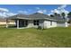 Single-story home with covered patio and landscaped lawn at 7160 Sw 179Th Court Rd, Dunnellon, FL 34432