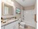 Updated bathroom features granite countertop, white vanity, and a shower/tub combo at 17 Locust Radial Crse, Ocala, FL 34472
