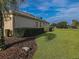 Side view of house showing lush landscaping and golf course views at 9240 Se 128Th Ln, Summerfield, FL 34491