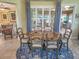 Bright dining room with a round table and six chairs, features a view into the Gathering room at 9240 Se 128Th Ln, Summerfield, FL 34491