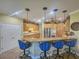 Kitchen with island, breakfast bar, and stainless steel appliances at 9240 Se 128Th Ln, Summerfield, FL 34491