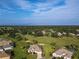 Community overview showing numerous houses and golf course at 9240 Se 128Th Ln, Summerfield, FL 34491
