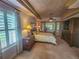 Main bedroom with a king-size bed, window seat, and large windows at 9240 Se 128Th Ln, Summerfield, FL 34491